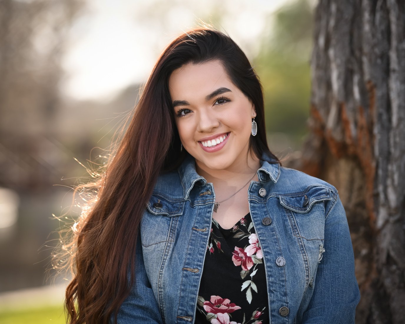 Beautiful young high school girl posing for graduation pictures.